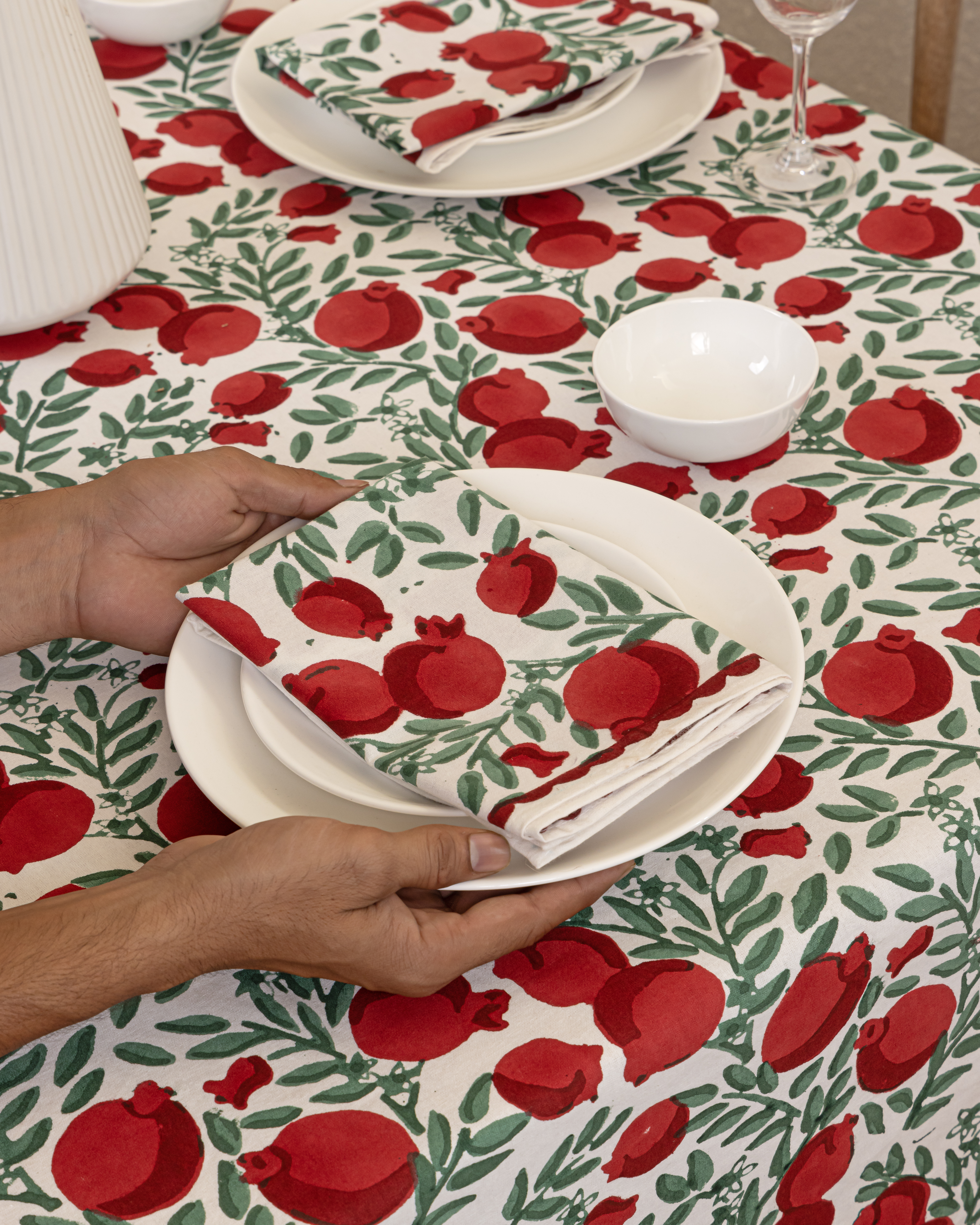 hand holding plate with block printed napkin and tablecloth
