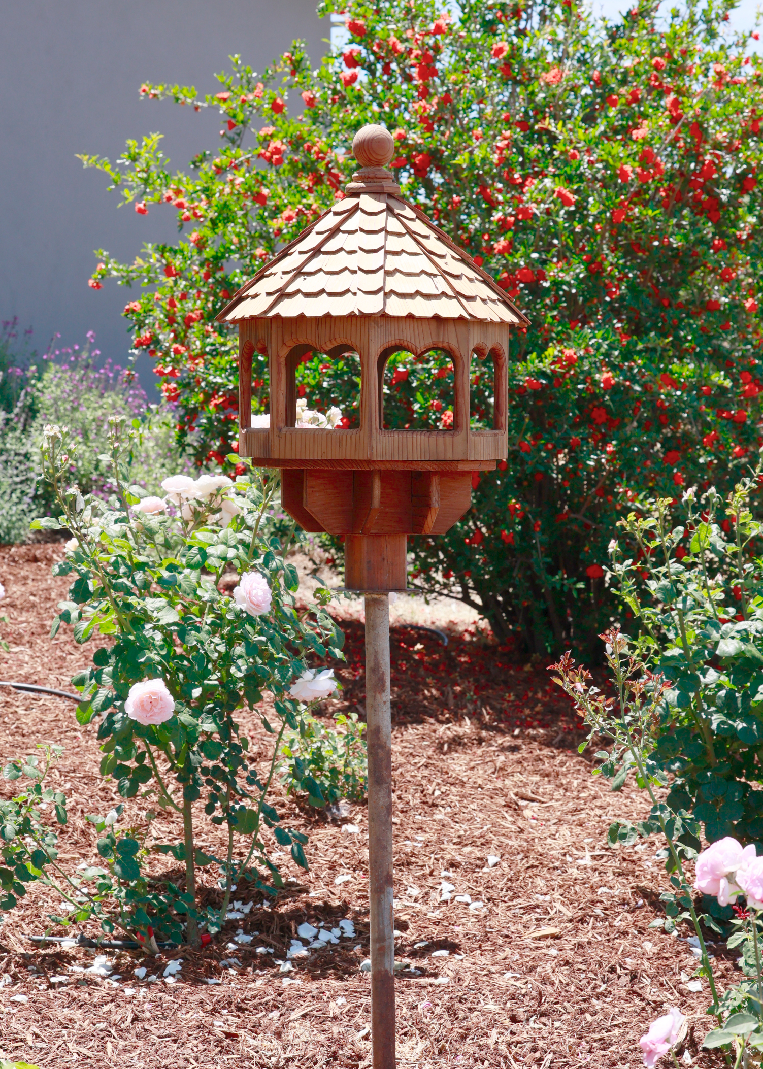 circular wooden bird hours with arched windows