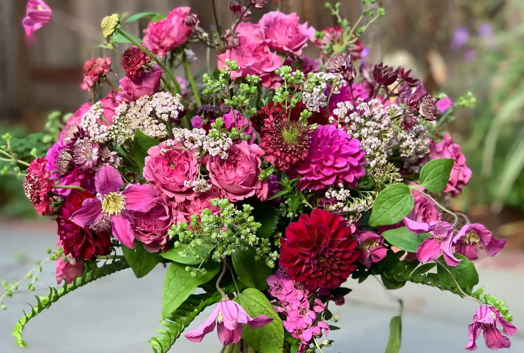 magenta and pink flowers in hand tied bouquet