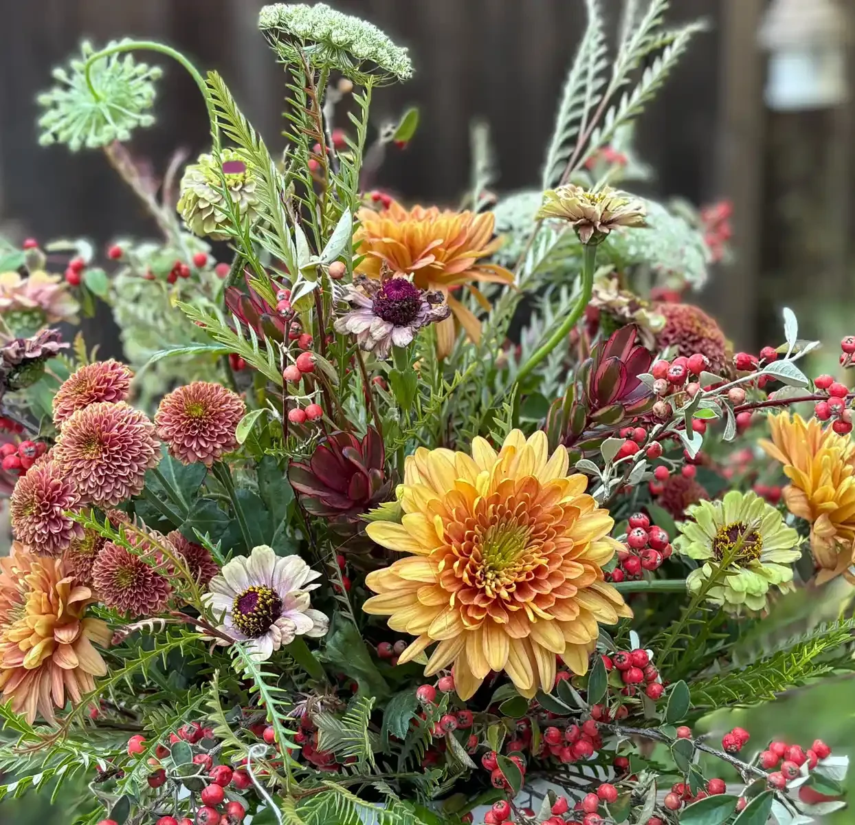 orange and yellow autumn flower bouquet with green foliage