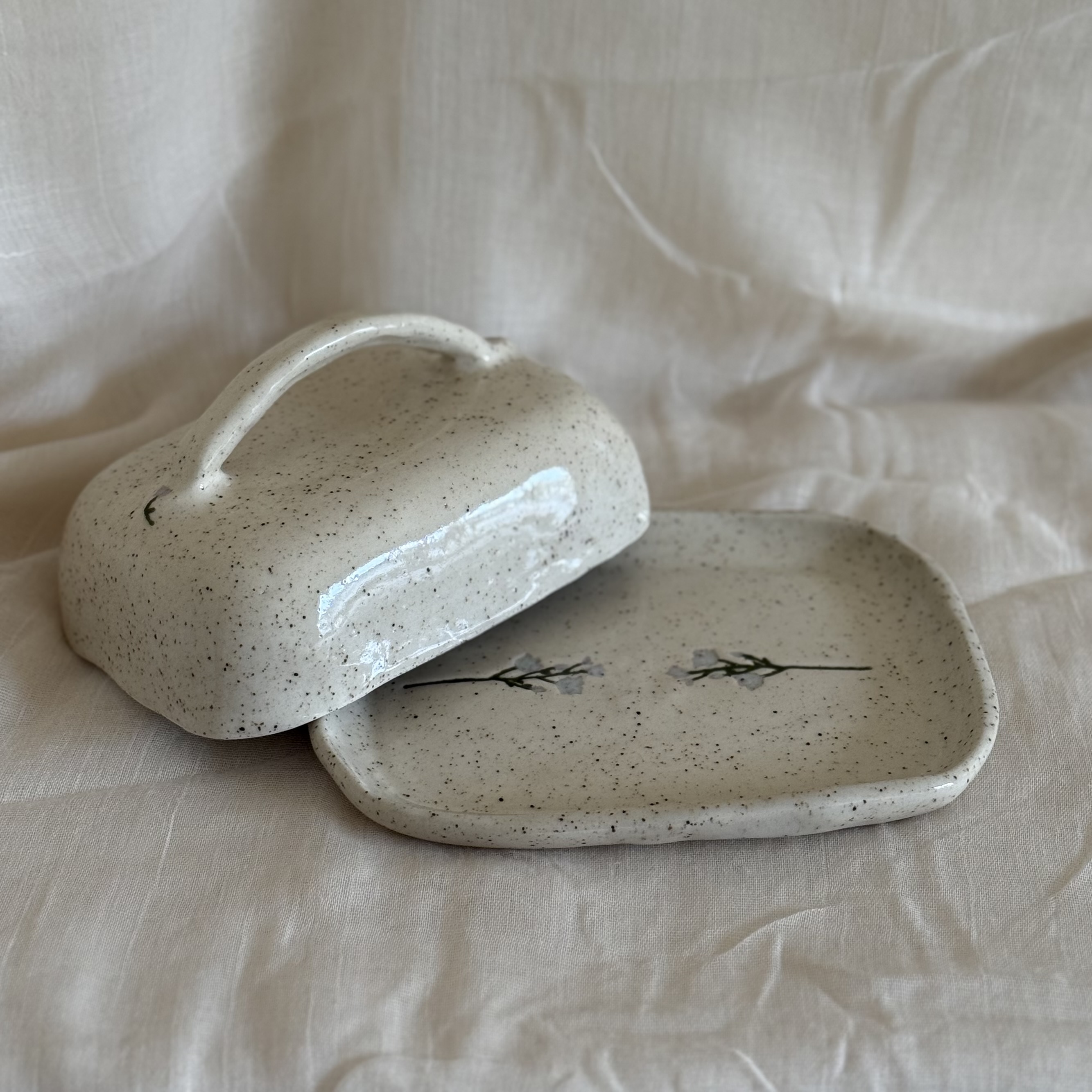 white speckled ceramic butter dish